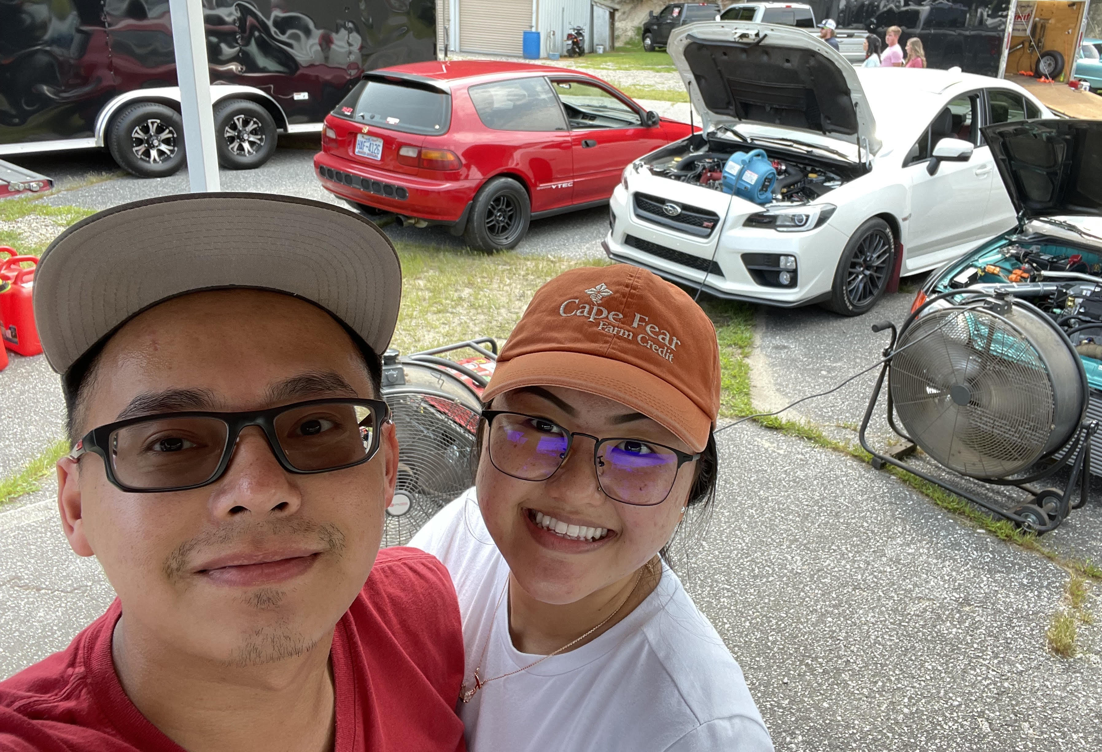 Alex with his wife at a car meet